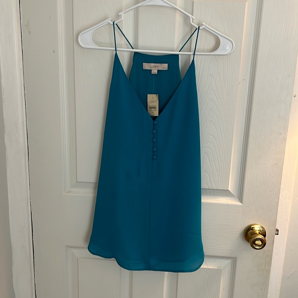 I am selling a new beautiful dressy shirt. Made by LOFT size SP